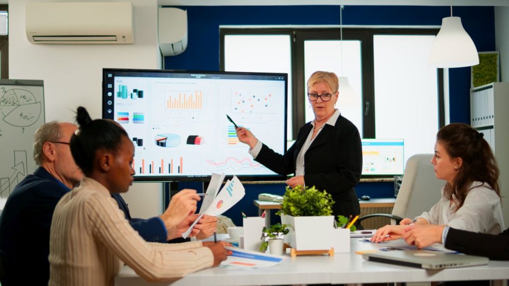 chief analyst showing financials on smart whiteboard