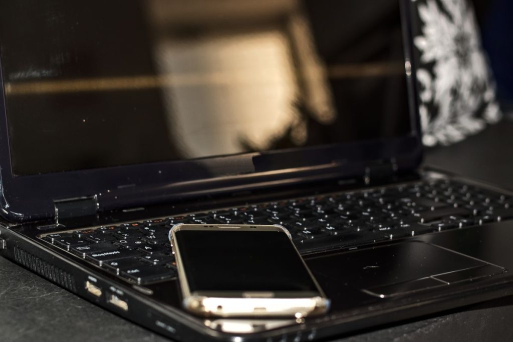 smartphone lying on laptop