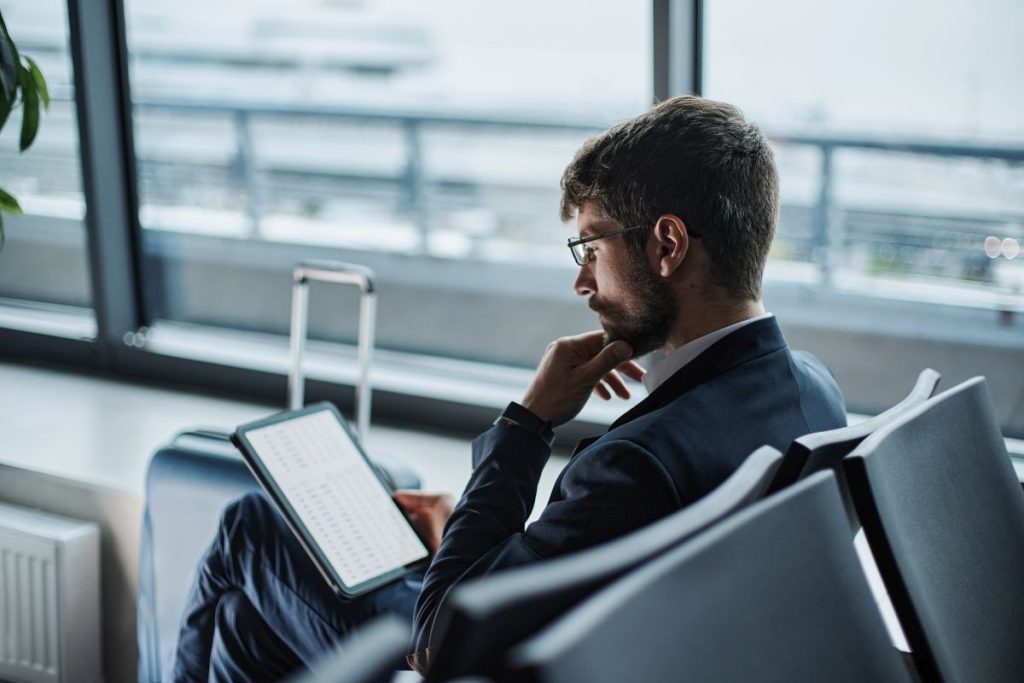 business man reading tablet at airport